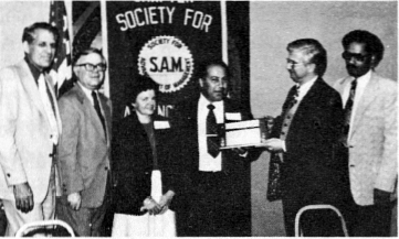 Black and White photo of Edward Miner receives the Orange Coast chapter's Manager of the Year Award. From left: Donald Callahan, Cliff Doubek, Mrs. Norma Miner, Edward Miner, Donald Begosh, and Charles Smith.