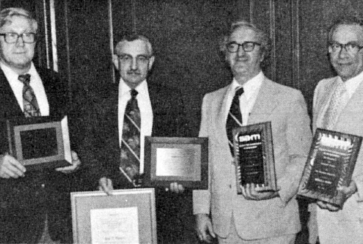 Black and White photo of members Receiving awards at the Board of Direc­tors meeting were (I. to r.) Alexander Kindling, new president-elect, who holds his "Professional Manager" cita­tion; Hal Batten, who was presented with both a "Professional Manager" citation and a "Certificate of Merit" for his work on behalf of S.A.M. as its international president; and Guy De Genaro and Michael A. Palmer, who re­ceived "Distinguished Service" plaques for their efforts as vice-presidents of Regions #7 and #2, respectively. 